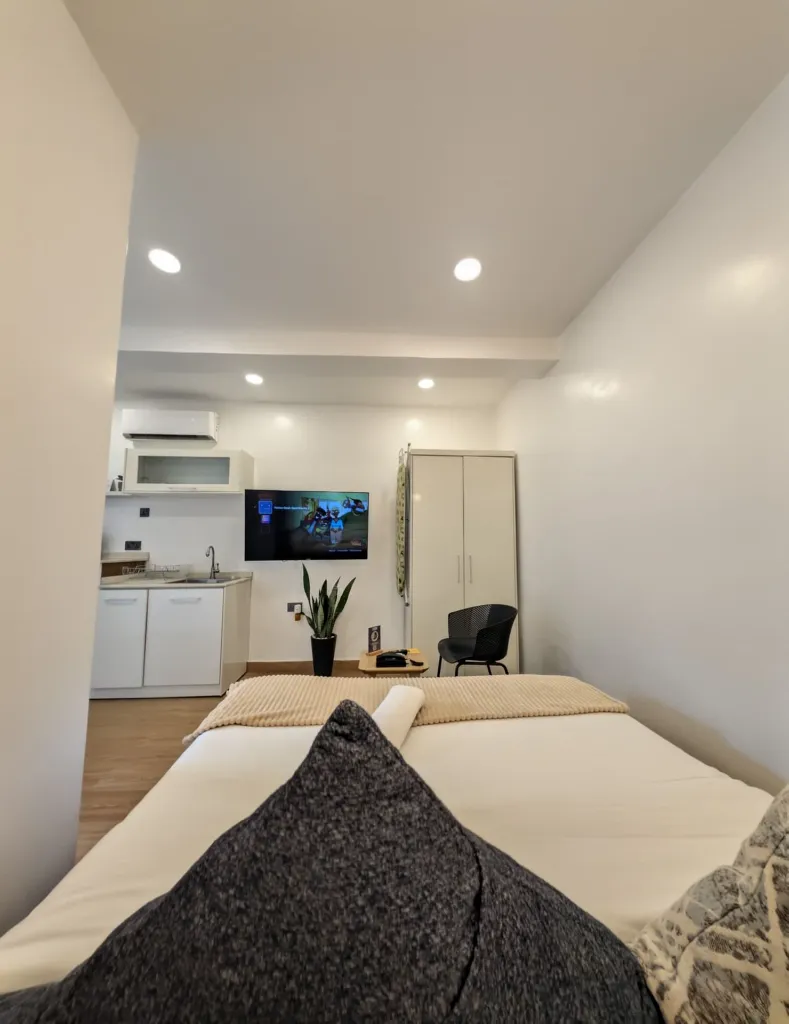 Ruby Studio full bedroom view with TV directly facing the Bed.webp