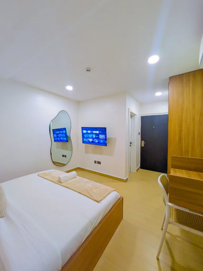 Room 206 Bedroom with balcony door view.webp